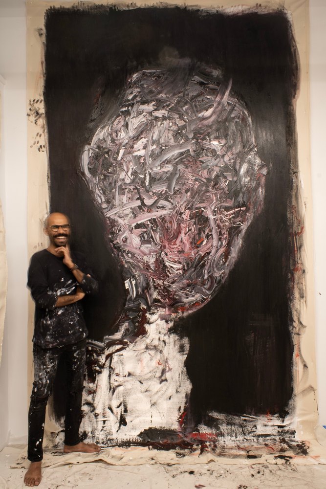Abdulrahman Hamdi in his studio, standing beside his large Self Portrait